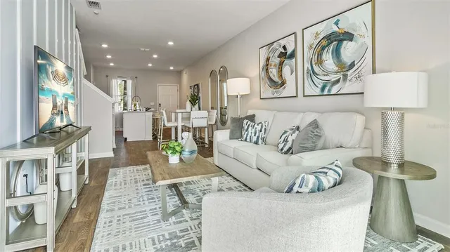 a living room with furniture and a painting