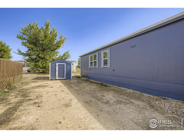 a view of a backyard with a large tree