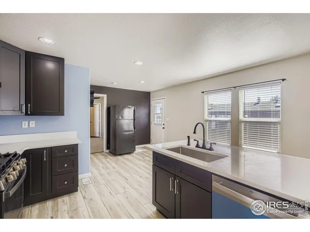 a kitchen with a sink cabinets and window