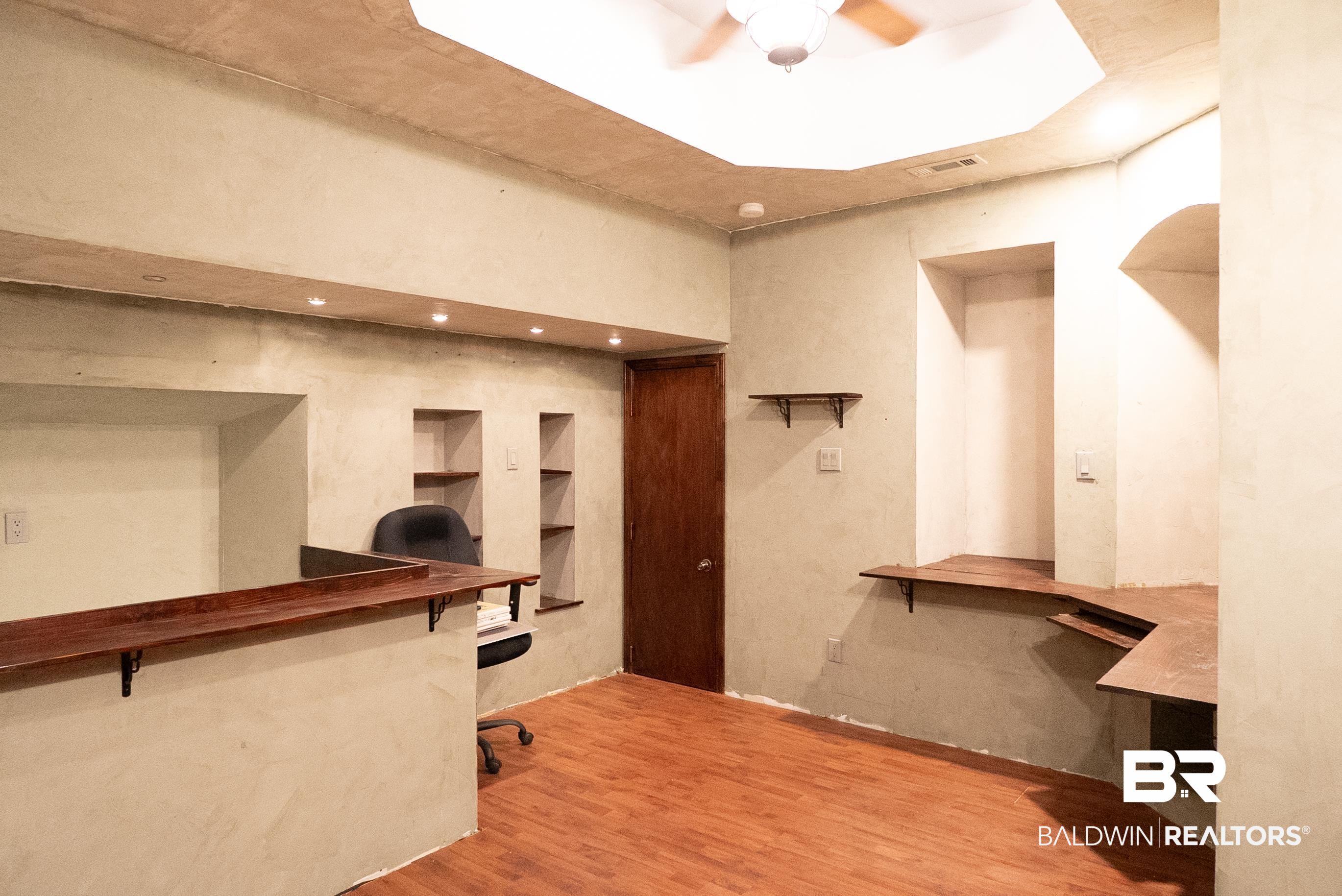 10023 Springfield Court Mobile, AL 36695 - Photo 47 of 50 Office area with light wood-type flooring, ceiling fan, and built in desk