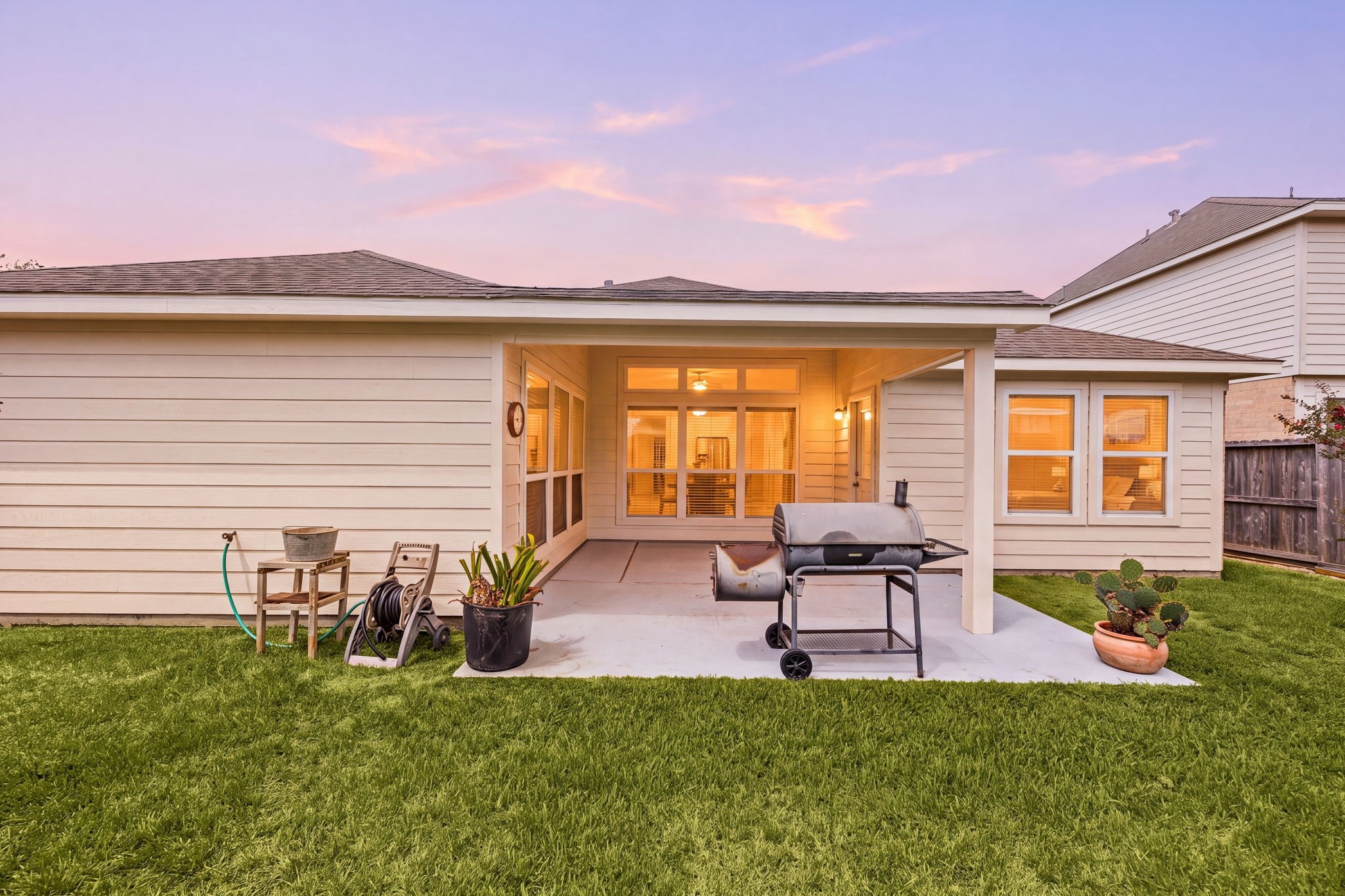 3102 Single Ridge Way Katy, TX 77493 - Photo 20 of 23 Fully fenced backyard showcasing a clear view of the covered back patio and a spacious lawn area.