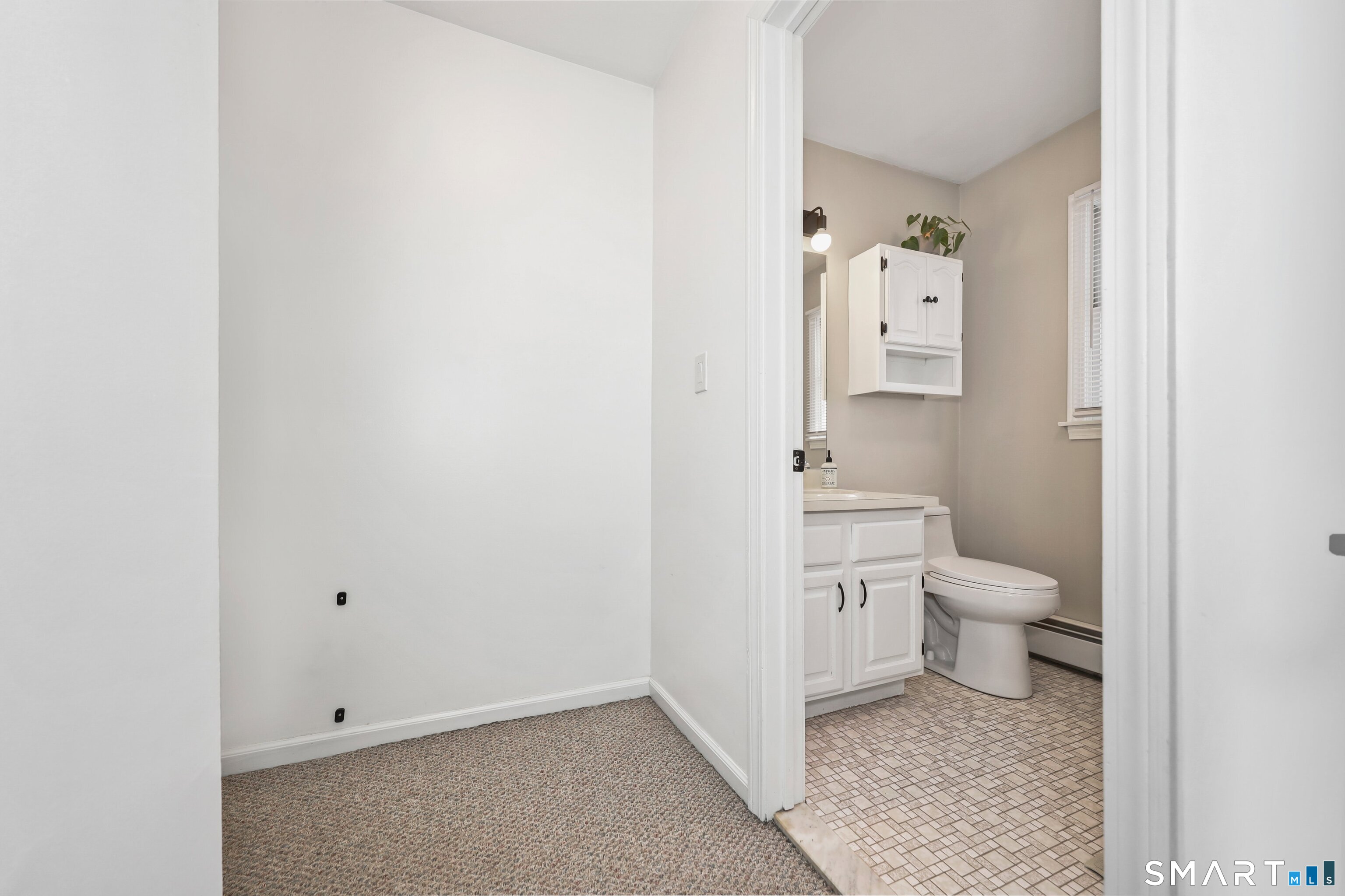 29 Toas Street, Unit 29 Shelton, CT 06484 - Photo 17 of 31 a bathroom with a toilet sink and a mirror