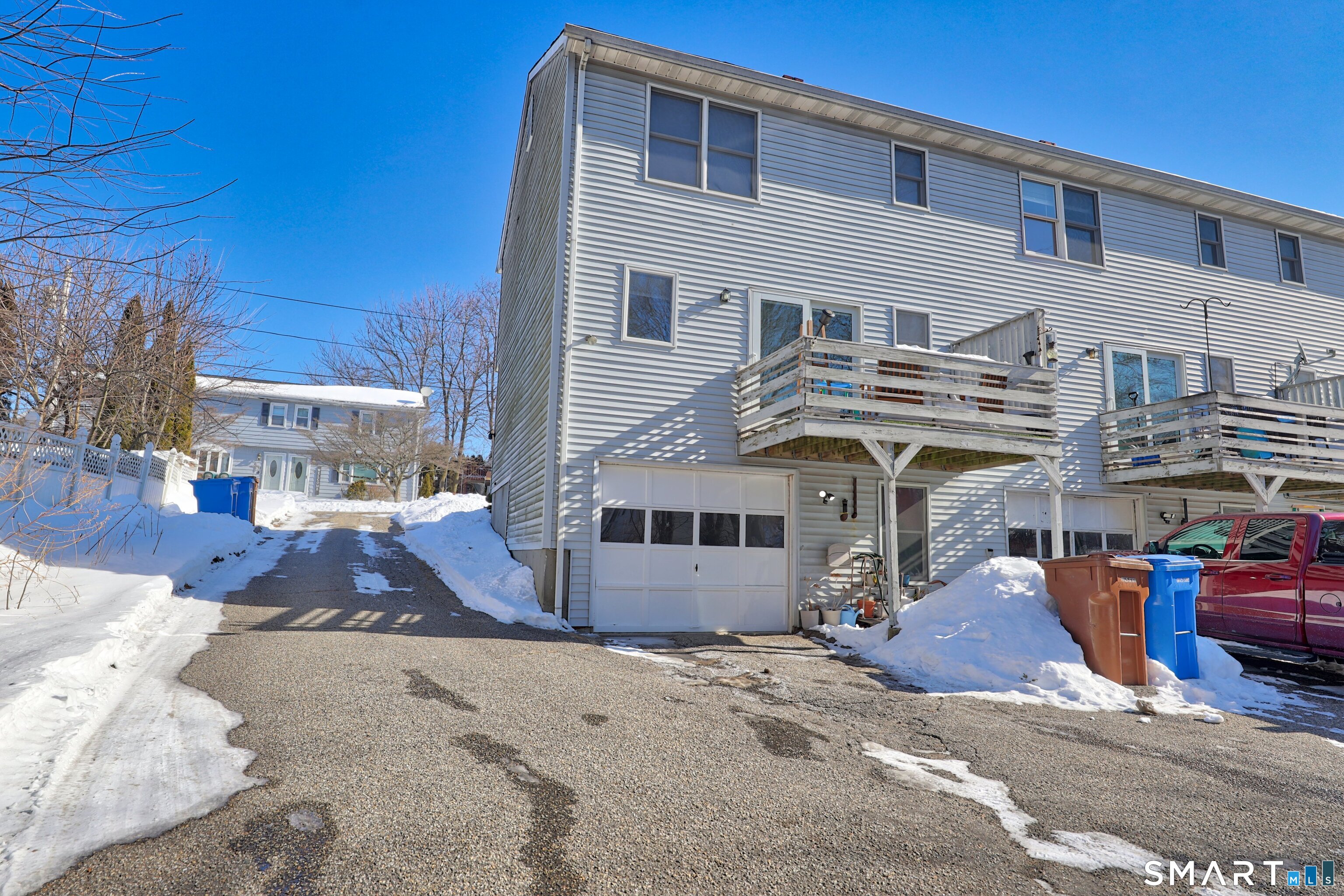 29 Toas Street, Unit 29 Shelton, CT 06484 - Photo 28 of 31 a front view of a house with a yard and garage