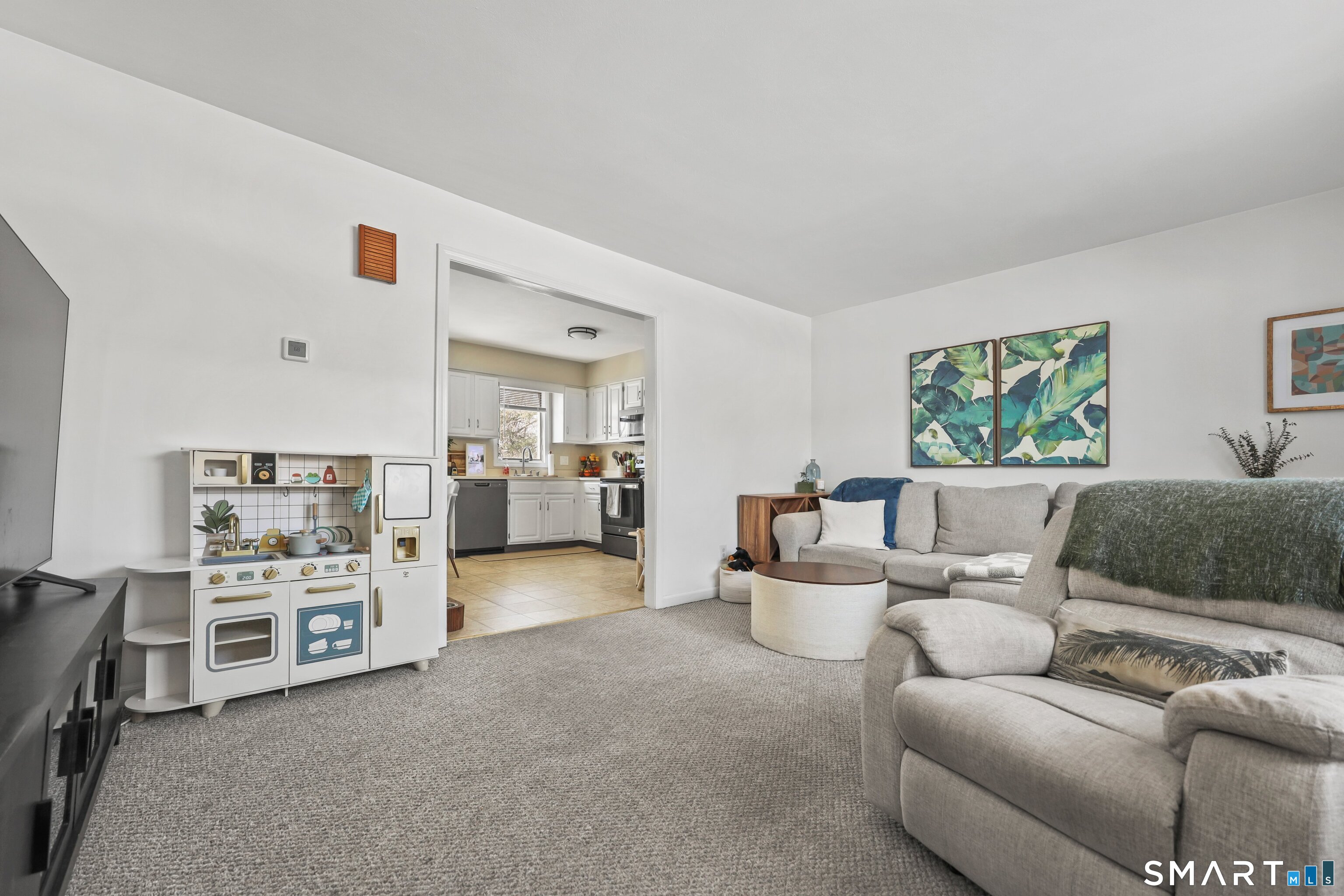 29 Toas Street, Unit 29 Shelton, CT 06484 - Photo 3 of 31 a living room with furniture and a wooden floor
