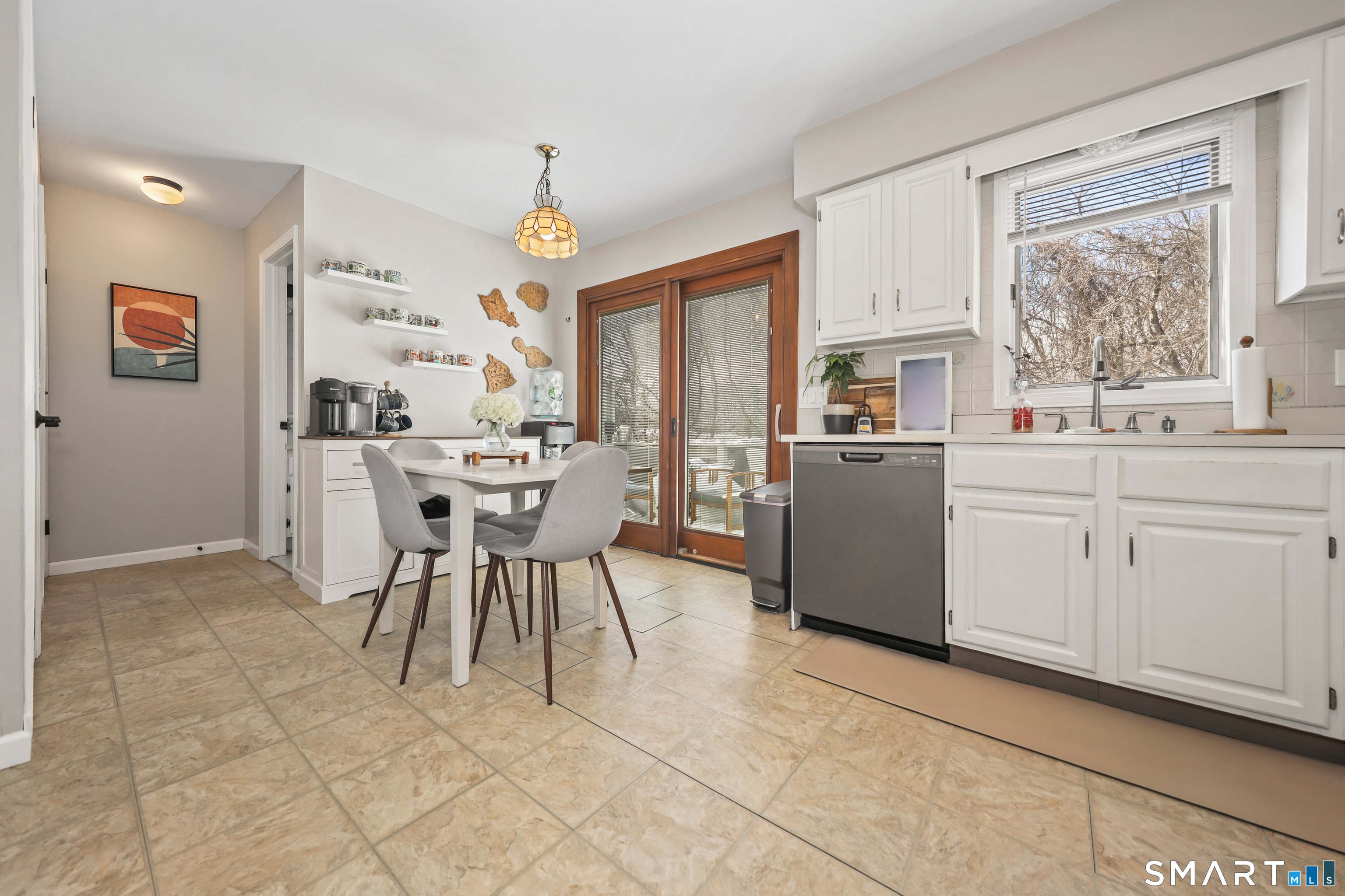 29 Toas Street, Unit 29 Shelton, CT 06484 - Photo 7 of 31 a dining room filled a chandelier and kitchen view