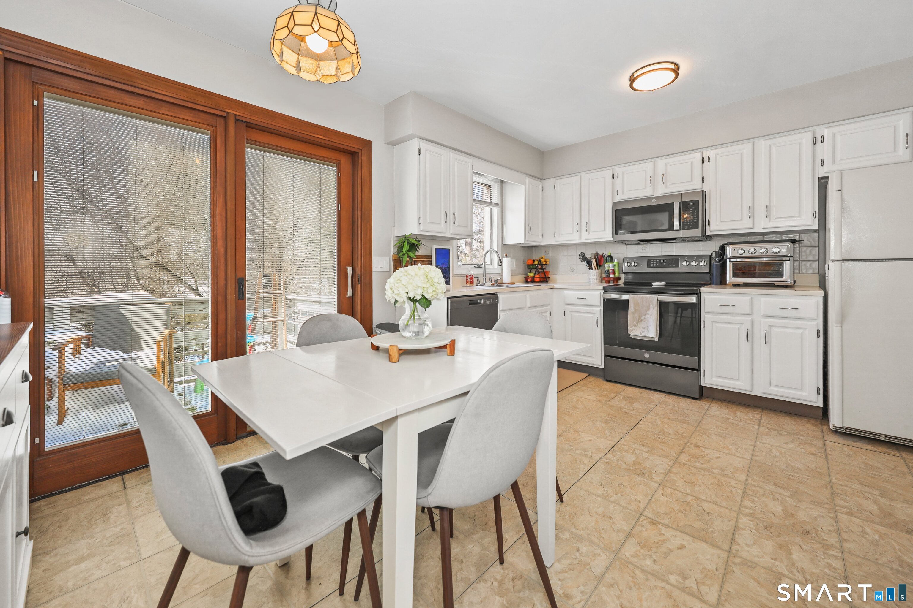 29 Toas Street, Unit 29 Shelton, CT 06484 - Photo 9 of 31 a view of kitchen with stainless steel appliances granite countertop dining table chairs and a refrigerator
