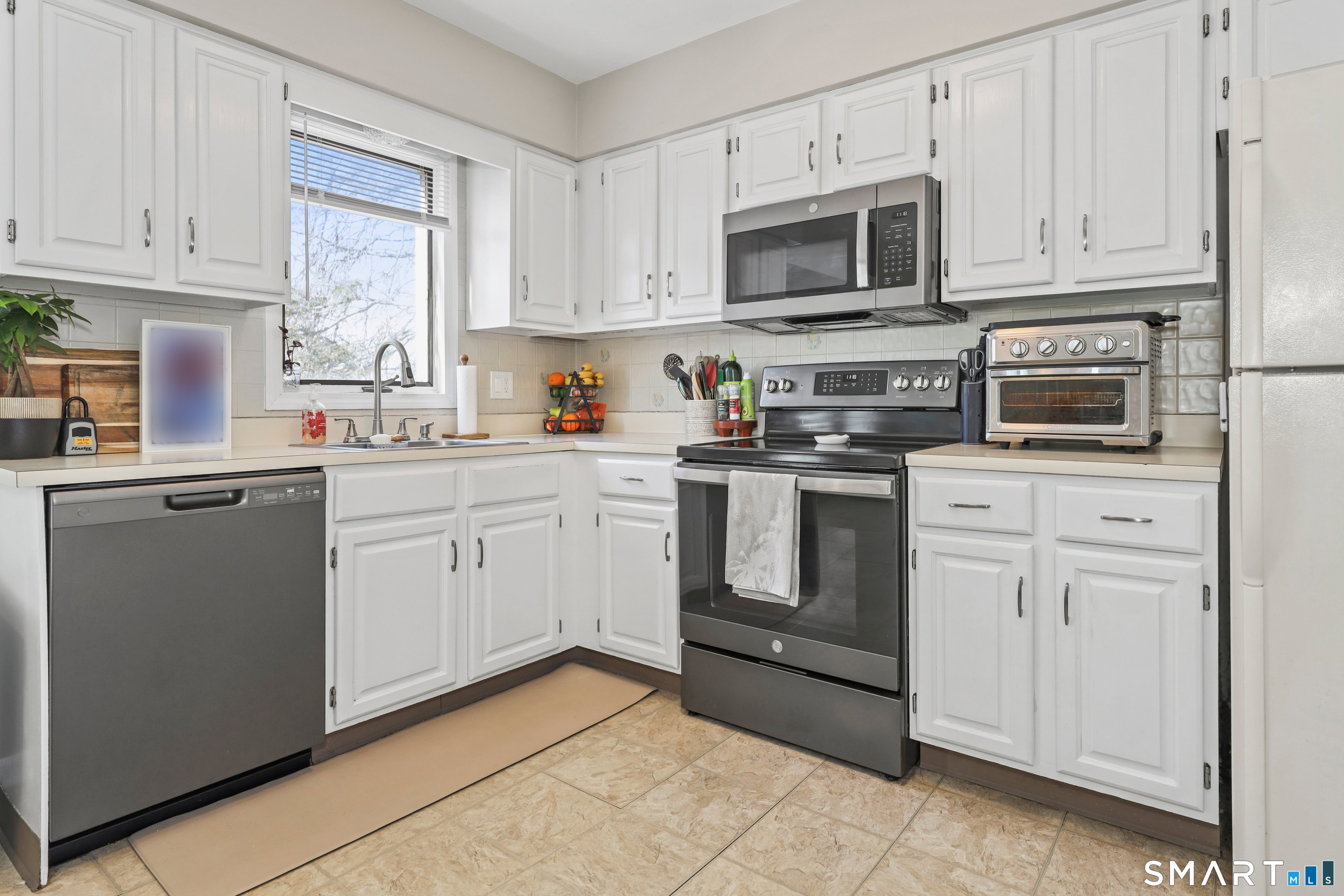29 Toas Street, Unit 29 Shelton, CT 06484 - Photo 10 of 31 a kitchen with cabinets stainless steel appliances and sink