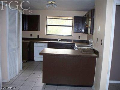 10760 Ruden Road North Fort Myers, FL 33917 - Photo 8 of 9 a kitchen with granite countertop a sink and a stove top oven