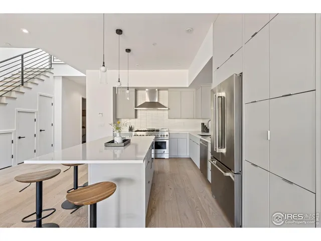 a kitchen with a sink a stove and chairs