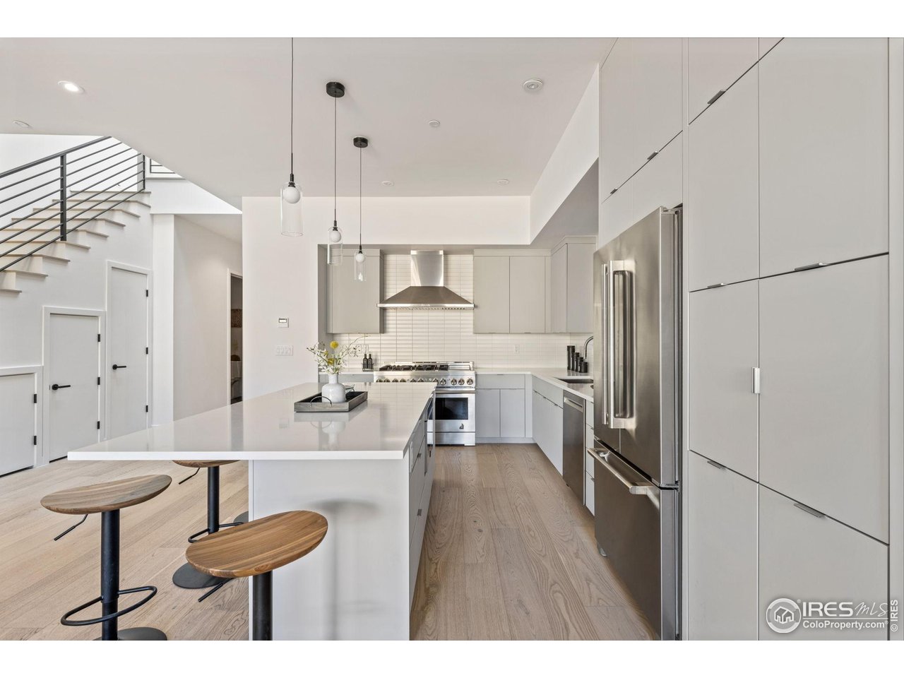 3315 Broadway Boulder, CO 80304 - Photo 2 of 42 a kitchen with stainless steel appliances a refrigerator a stove a sink dishwasher and white cabinets with wooden floor