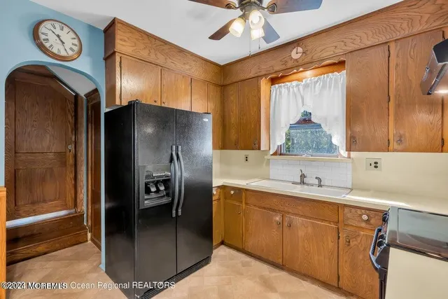 a kitchen with a refrigerator and a sink