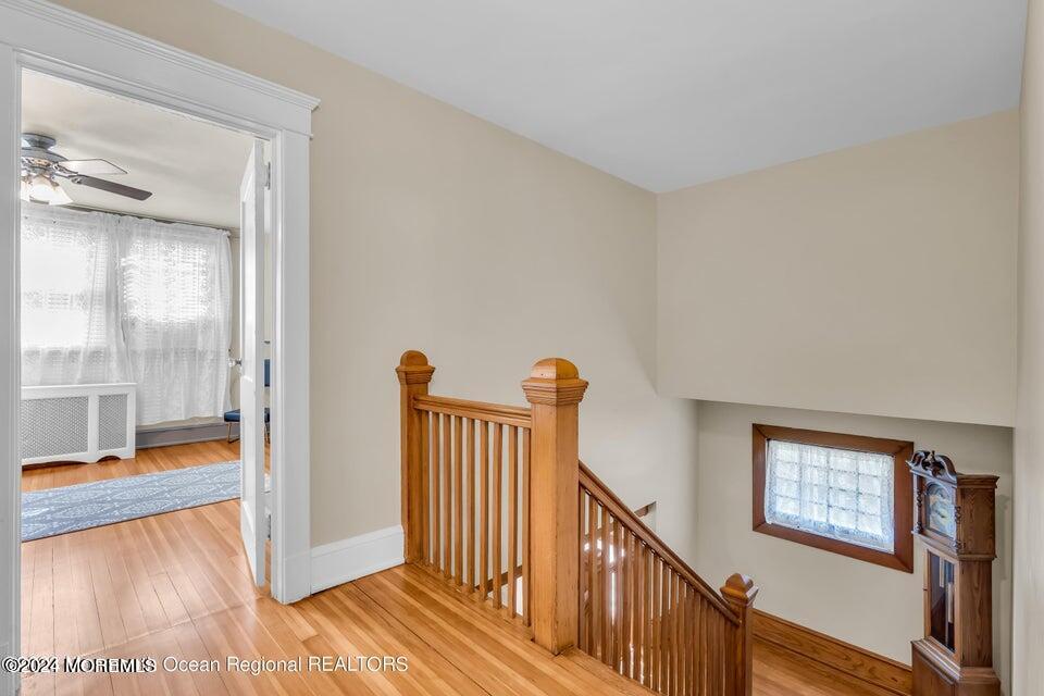 649 McClellan Street Long Branch, NJ 07740 - Photo 23 of 33 a view of a hallway with wooden floor and windows