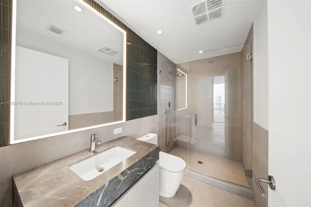 a bathroom with a sink a toilet and bathtub