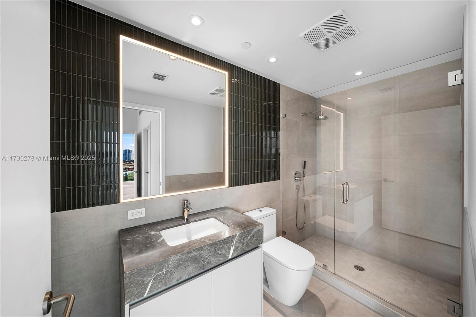 500 Alton Road, Unit 3101 Miami Beach, FL 33139 - Photo 19 of 53 a bathroom with a granite countertop sink a toilet and shower