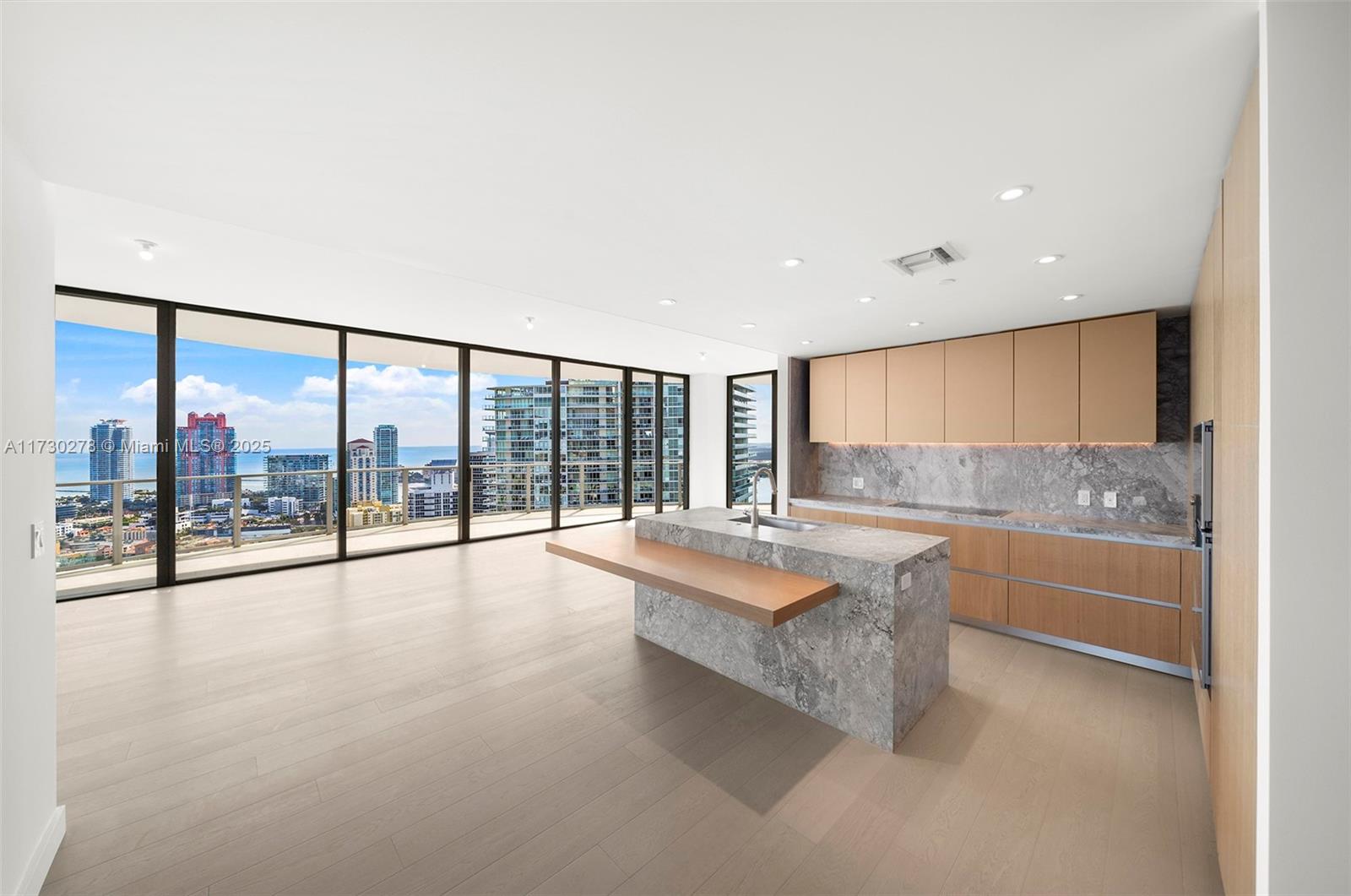 500 Alton Road, Unit 3101 Miami Beach, FL 33139 - Photo 2 of 53 a large white kitchen with granite countertop a large window and a sink