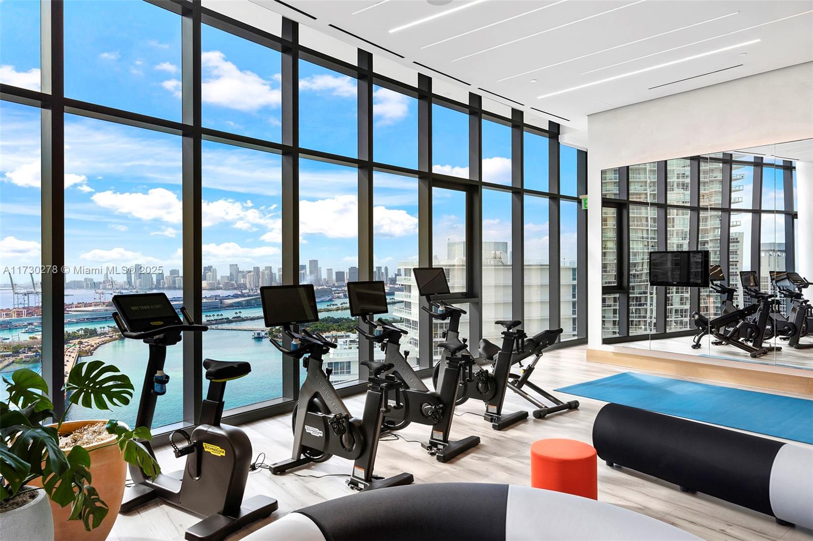 500 Alton Road, Unit 3101 Miami Beach, FL 33139 - Photo 28 of 53 a view of a room with gym equipment and floor to ceiling windows