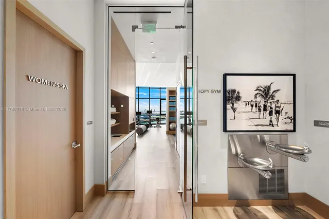 a living room with furniture and floor to ceiling windows