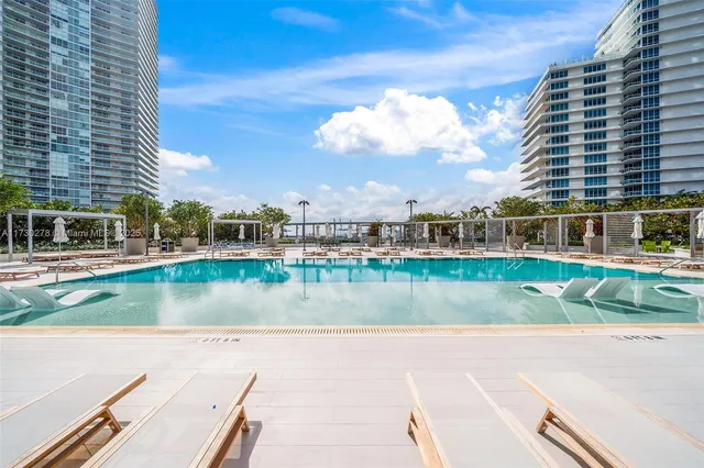 a view of a swimming pool with sitting area