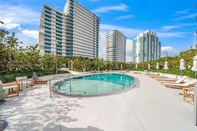 a view of a swimming pool with a lounge chairs