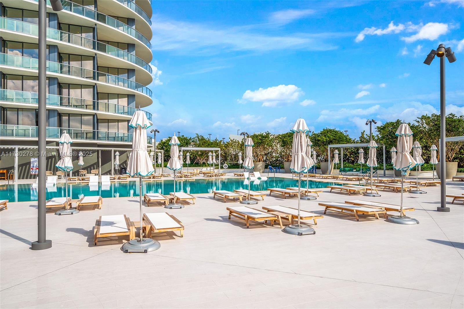 500 Alton Road, Unit 3101 Miami Beach, FL 33139 - Photo 52 of 53 a view of a swimming pool with a lounge chairs