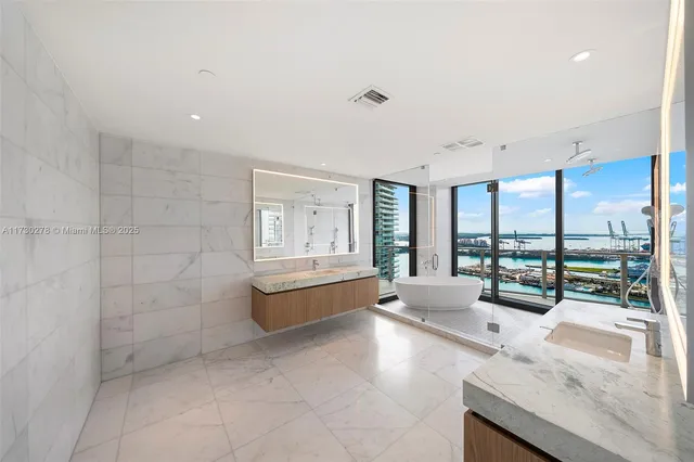 a bathroom with a bathtub and next to a window