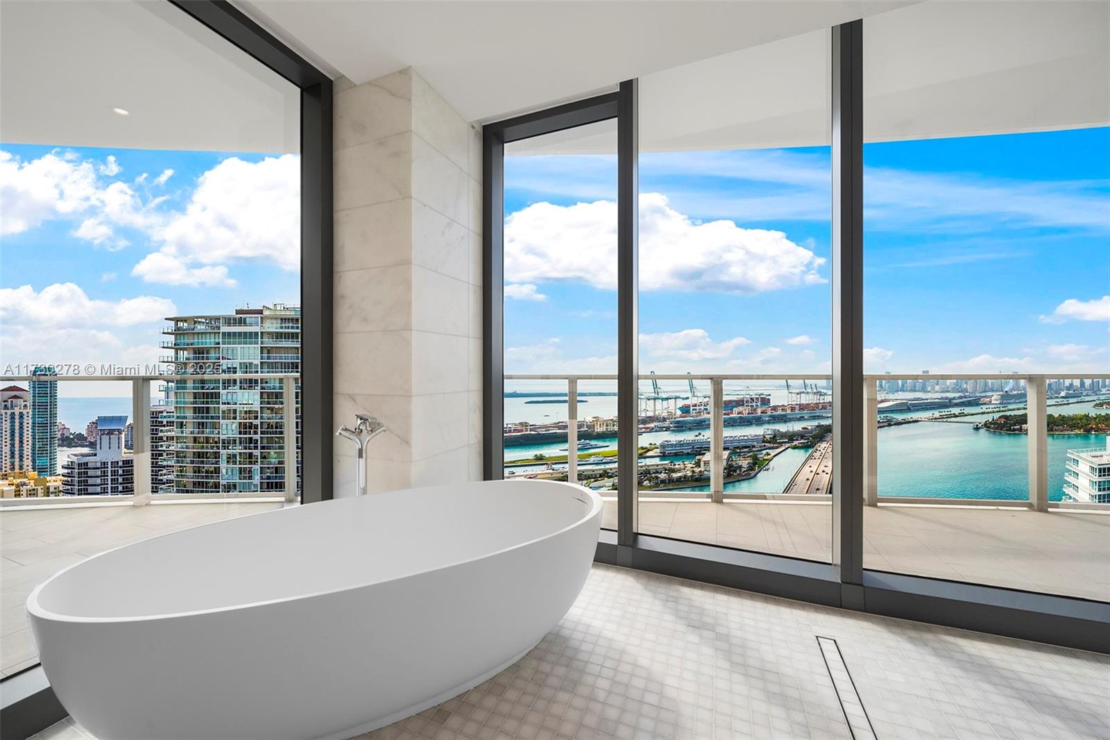 500 Alton Road, Unit 3101 Miami Beach, FL 33139 - Photo 9 of 53 a bathroom with a bathtub and next to a window