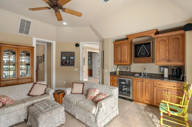 a bedroom with a bed a large window and chair