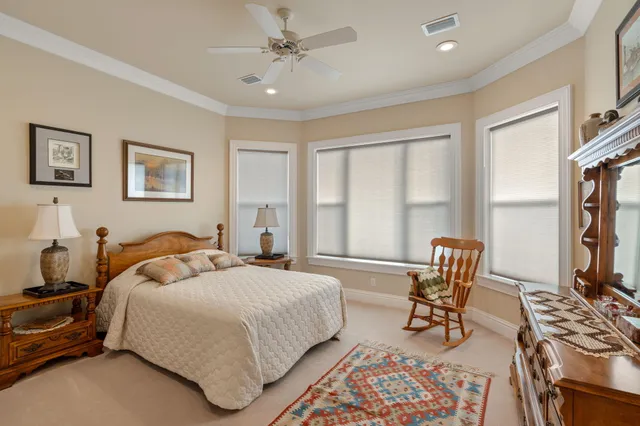 a bedroom with a bed a dresser and book shelf