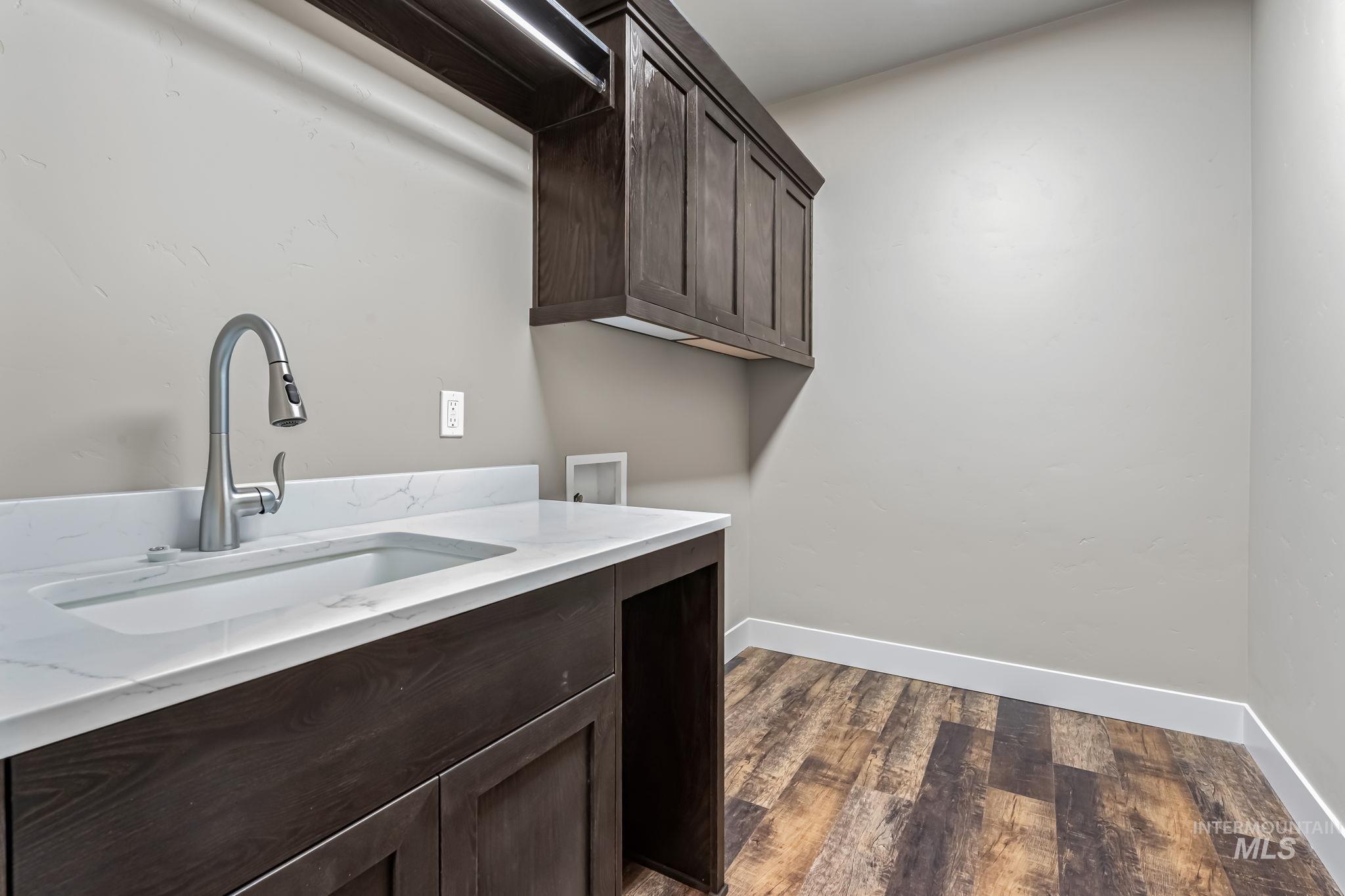 2755 Cypress Point Payette, ID 83661 - Photo 12 of 28 Laundry area featuring dark wood-style flooring, cabinet space, and washer hookup