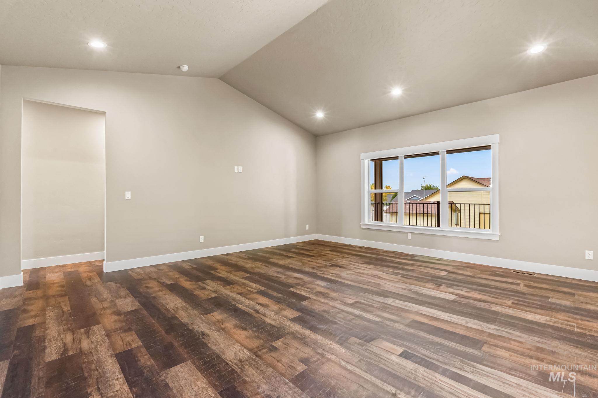 2755 Cypress Point Payette, ID 83661 - Photo 15 of 28 Unfurnished room with recessed lighting, vaulted ceiling, and dark wood-type flooring