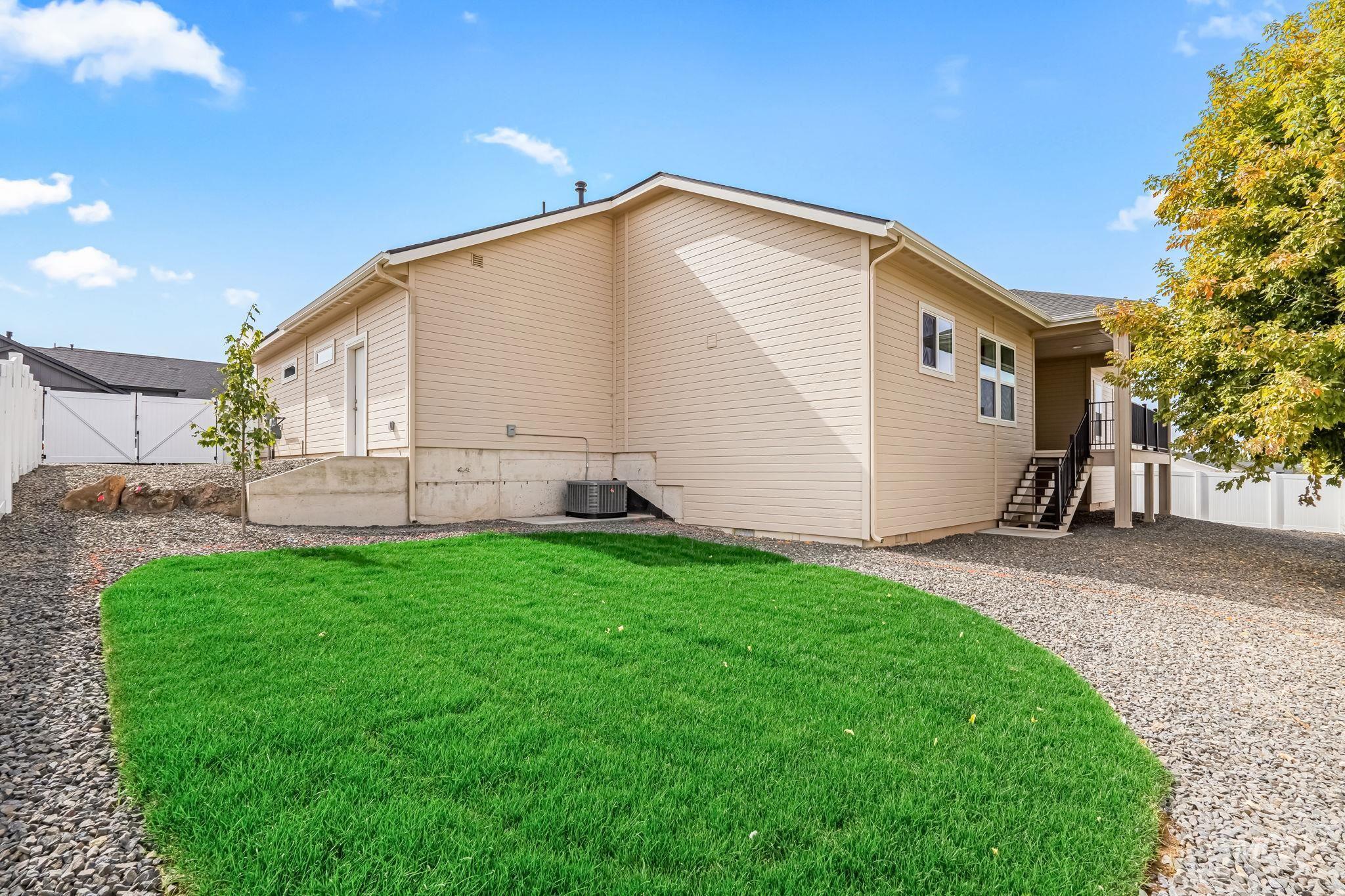 2755 Cypress Point Payette, ID 83661 - Photo 21 of 28 Rear view of house with a fenced backyard, stairs, and a gate