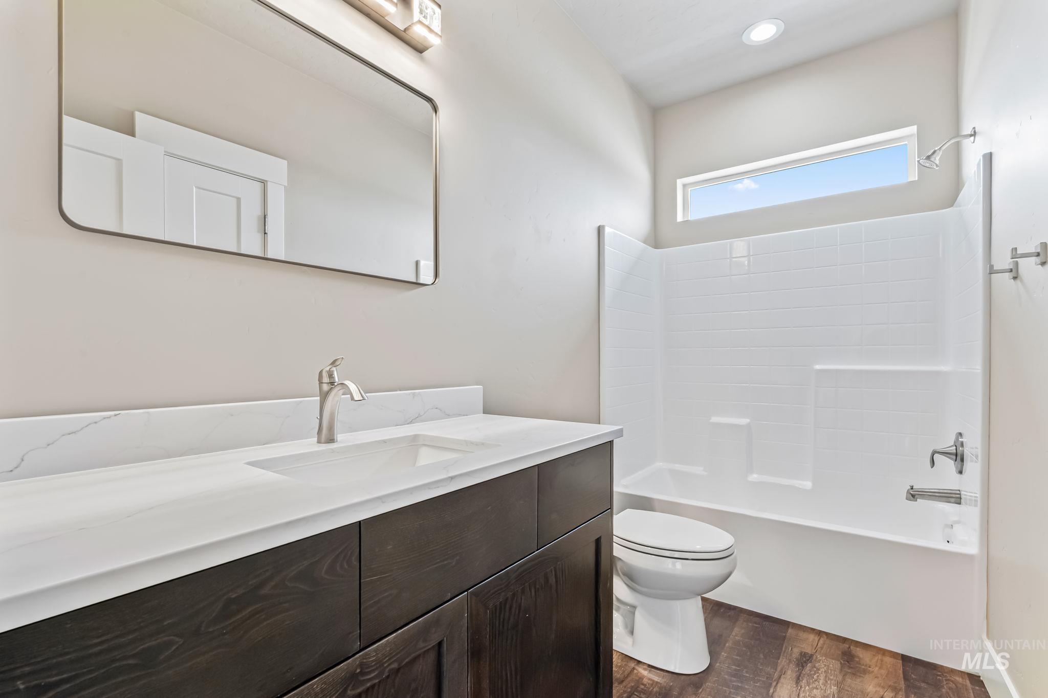 2755 Cypress Point Payette, ID 83661 - Photo 25 of 28 Full bathroom with tub / shower combination, dark wood finished floors, and vanity