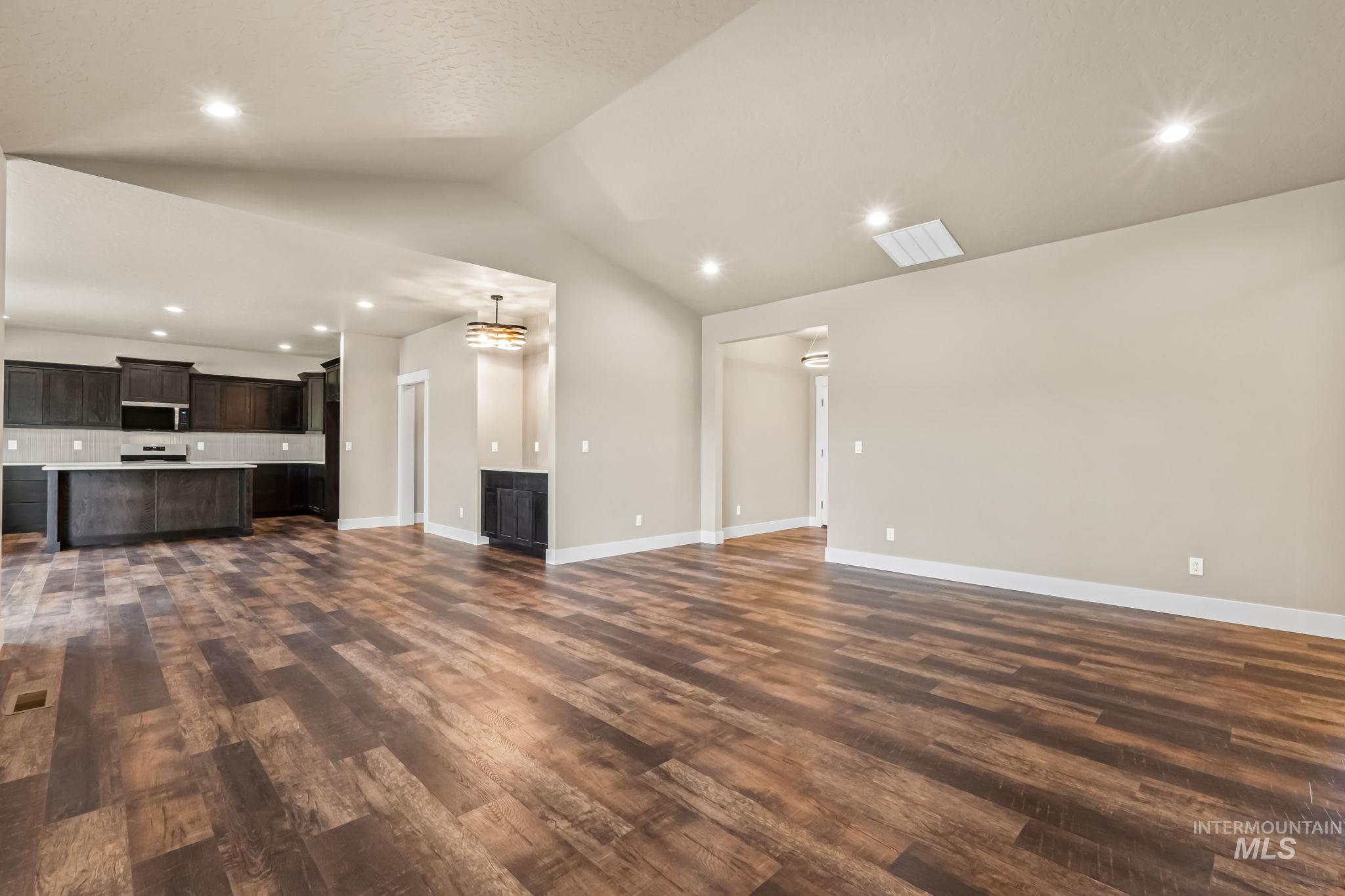 2755 Cypress Point Payette, ID 83661 - Photo 7 of 28 Unfurnished living room with recessed lighting, lofted ceiling, and dark wood-type flooring