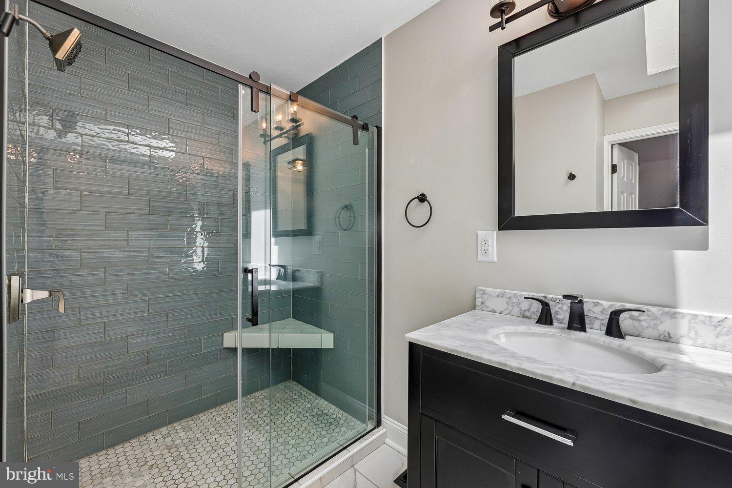 15764 Beau Ridge Drive Woodbridge, VA 22193 - Photo 25 of 58 a bathroom with a sink a mirror and a shower