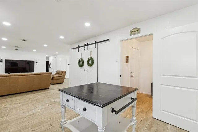 a kitchen with a stove a refrigerator and a table