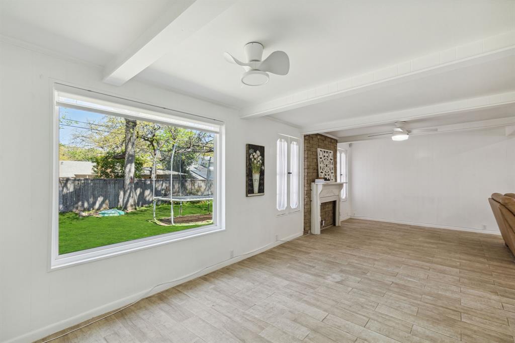 724 Edgehill Drive Hurst, TX 76053 - Photo 14 of 27 a view of empty room with wooden floor and fan