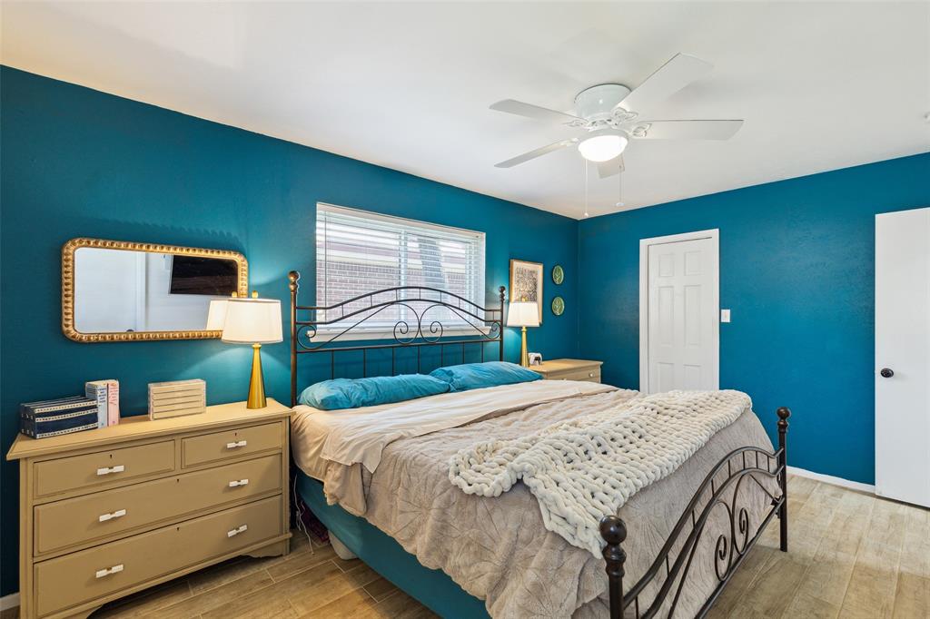 724 Edgehill Drive Hurst, TX 76053 - Photo 16 of 27 a bedroom with a bed and a chandelier