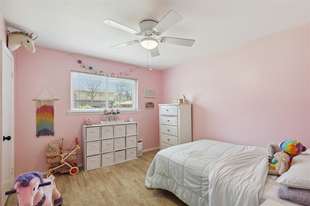 724 Edgehill Drive Hurst, TX 76053 - Photo 18 of 27 a bedroom with a bed and a window