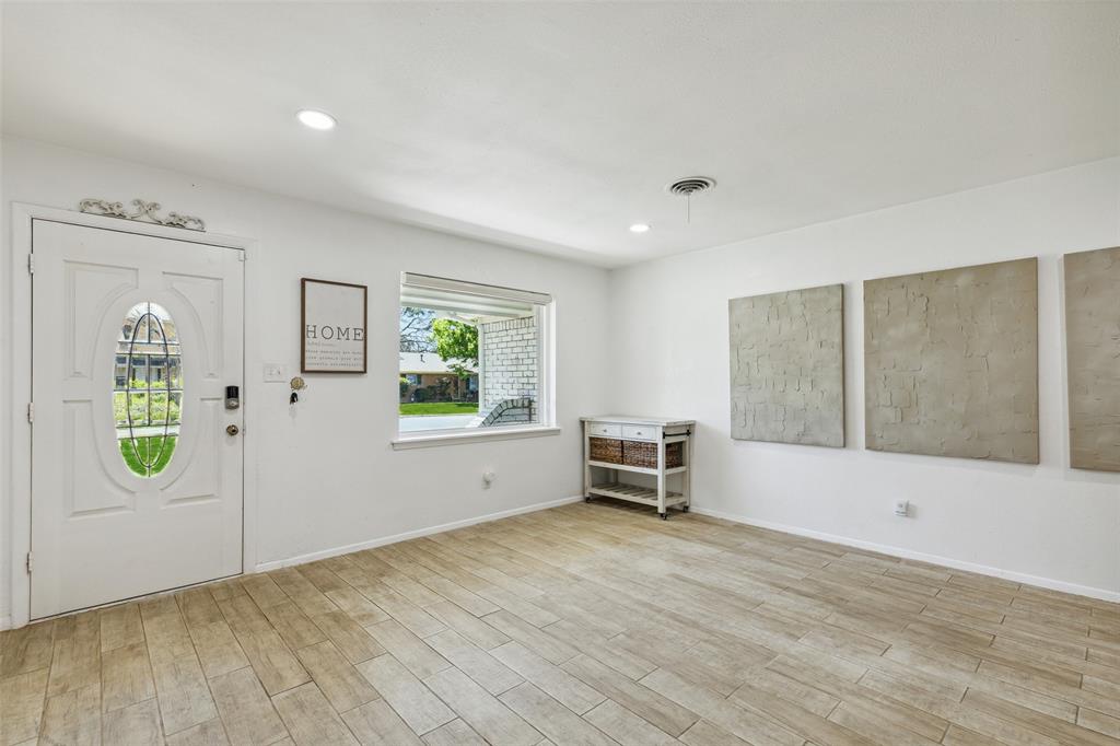 724 Edgehill Drive Hurst, TX 76053 - Photo 22 of 27 wooden floor in an empty room with a window