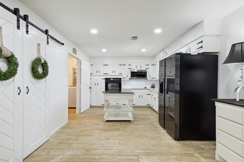 724 Edgehill Drive Hurst, TX 76053 - Photo 23 of 27 a view of kitchen with stainless steel appliances kitchen island refrigerator stove and microwave
