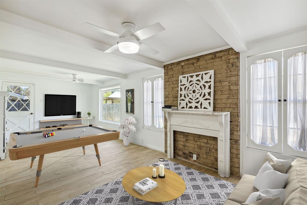 724 Edgehill Drive Hurst, TX 76053 - Photo 27 of 27 a living room with furniture a fireplace and a flat screen tv