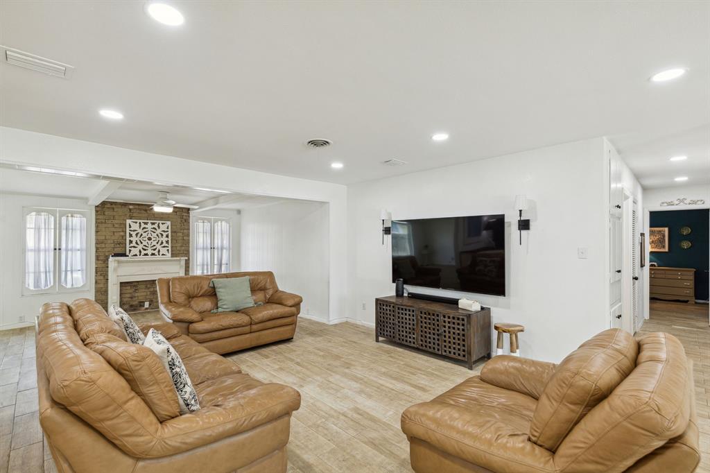 724 Edgehill Drive Hurst, TX 76053 - Photo 5 of 27 a living room with furniture and a flat screen tv
