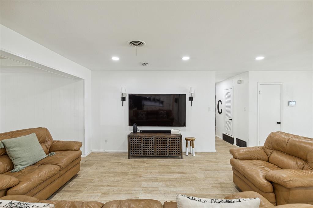 724 Edgehill Drive Hurst, TX 76053 - Photo 6 of 27 a living room with furniture and a flat screen tv