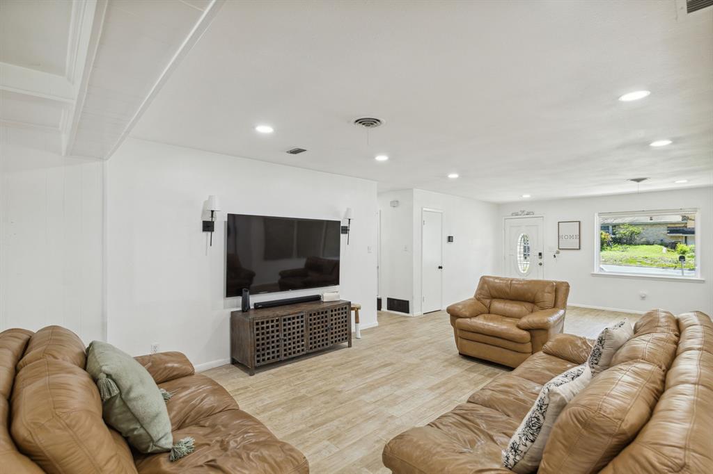 724 Edgehill Drive Hurst, TX 76053 - Photo 7 of 27 a living room with furniture and a flat screen tv