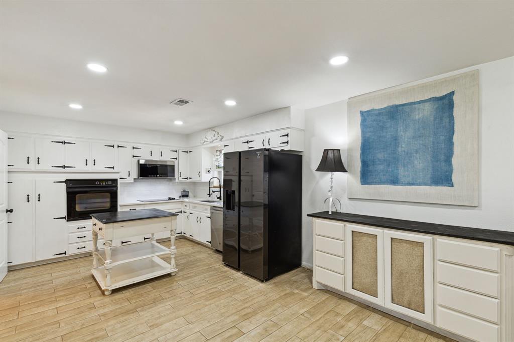 724 Edgehill Drive Hurst, TX 76053 - Photo 9 of 27 a kitchen with stainless steel appliances a refrigerator sink and microwave