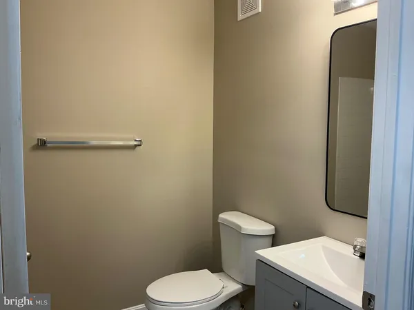 a white toilet sitting next to a bathroom sink
