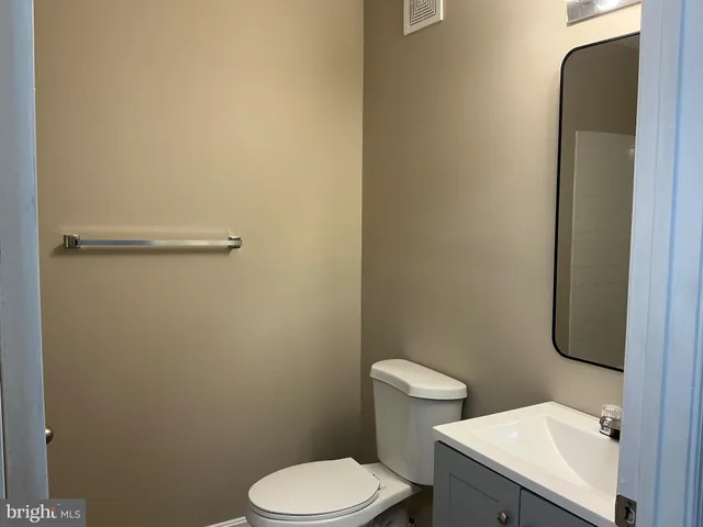 a white toilet sitting next to a bathroom sink