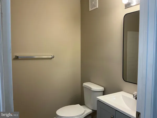 a white toilet sitting next to a bathroom sink