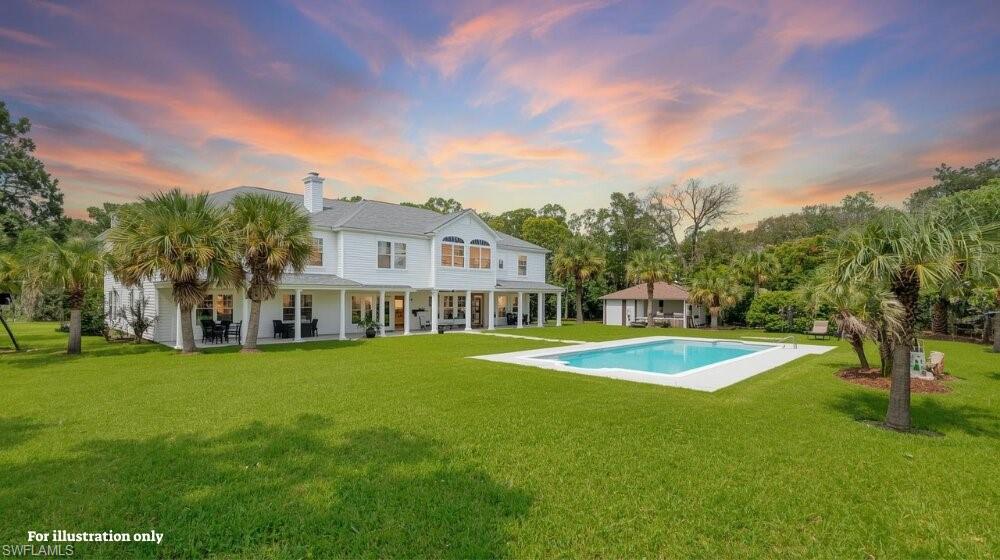 85070 Burmeister Road Fernandina Beach, FL 32034 - Photo 6 of 6 Back of property at dusk with a patio area, a yard, an outdoor pool, and a chimney