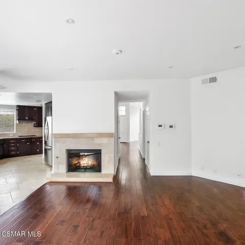 a view of a livingroom with a fireplace and wooden floor